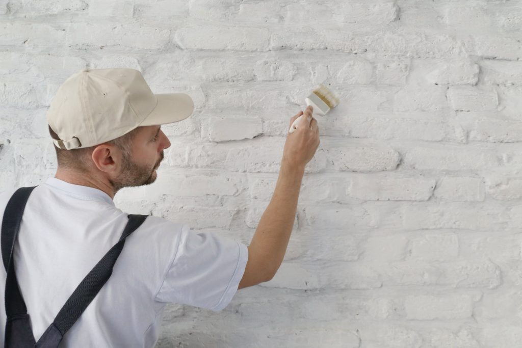 Professional Painter Painting Brick Wall